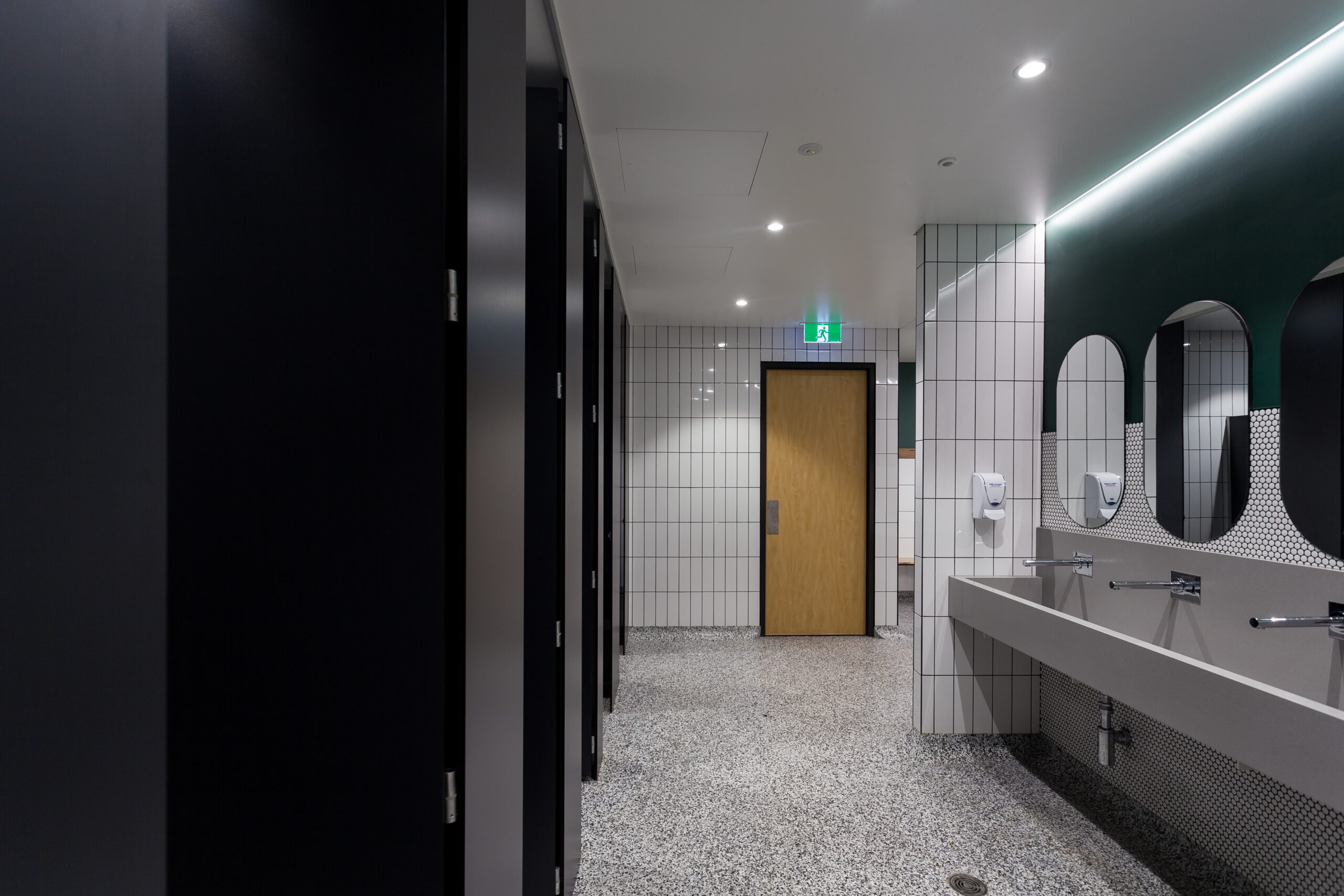 Epoxy flake floor installed in Cabra Dominican College changerooms — wide overview