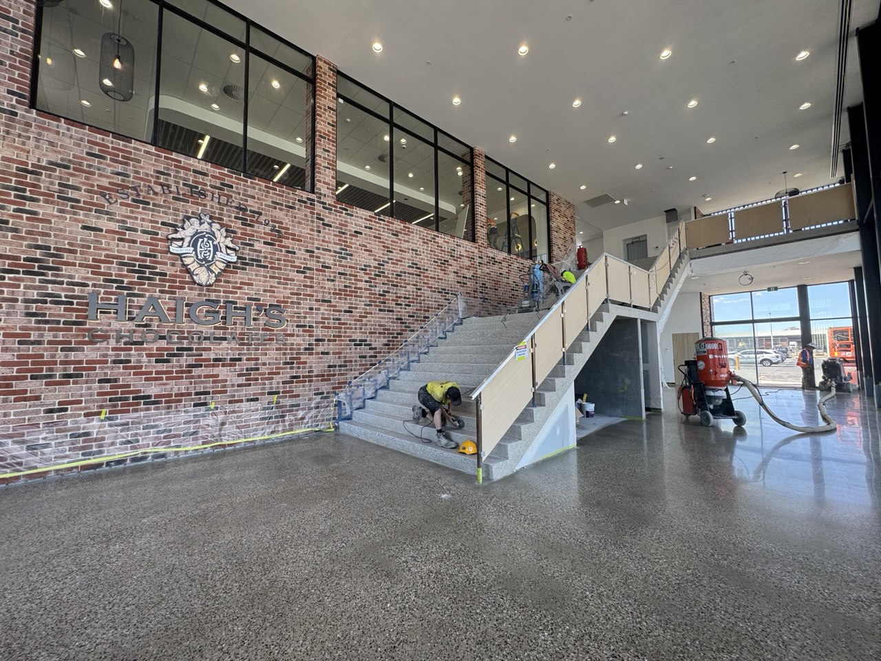 Polished concrete installation in progress — Haigh's Chocolates foyer