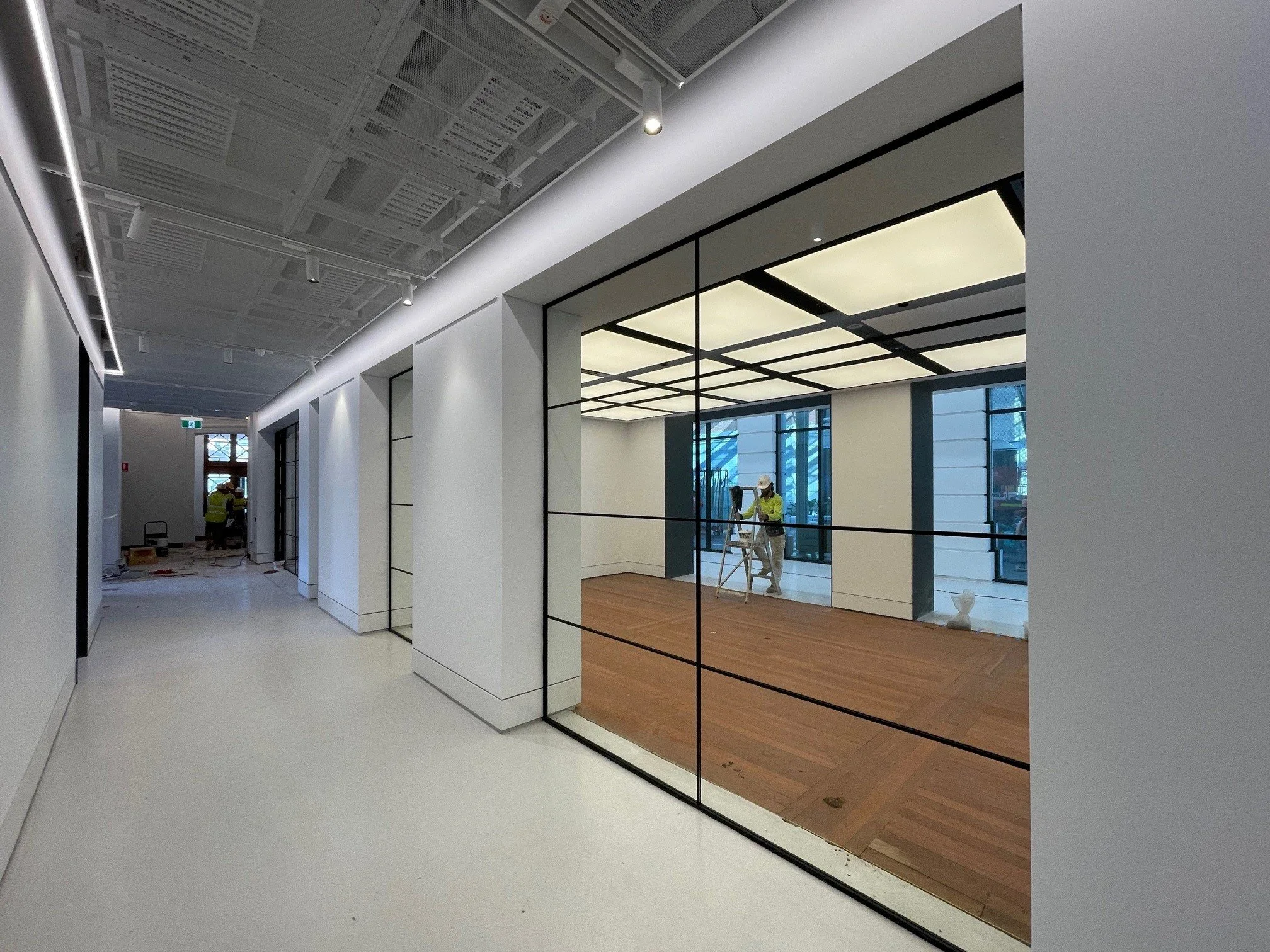 Light-coloured seamless epoxy floor — Bice Building fitout corridor under construction