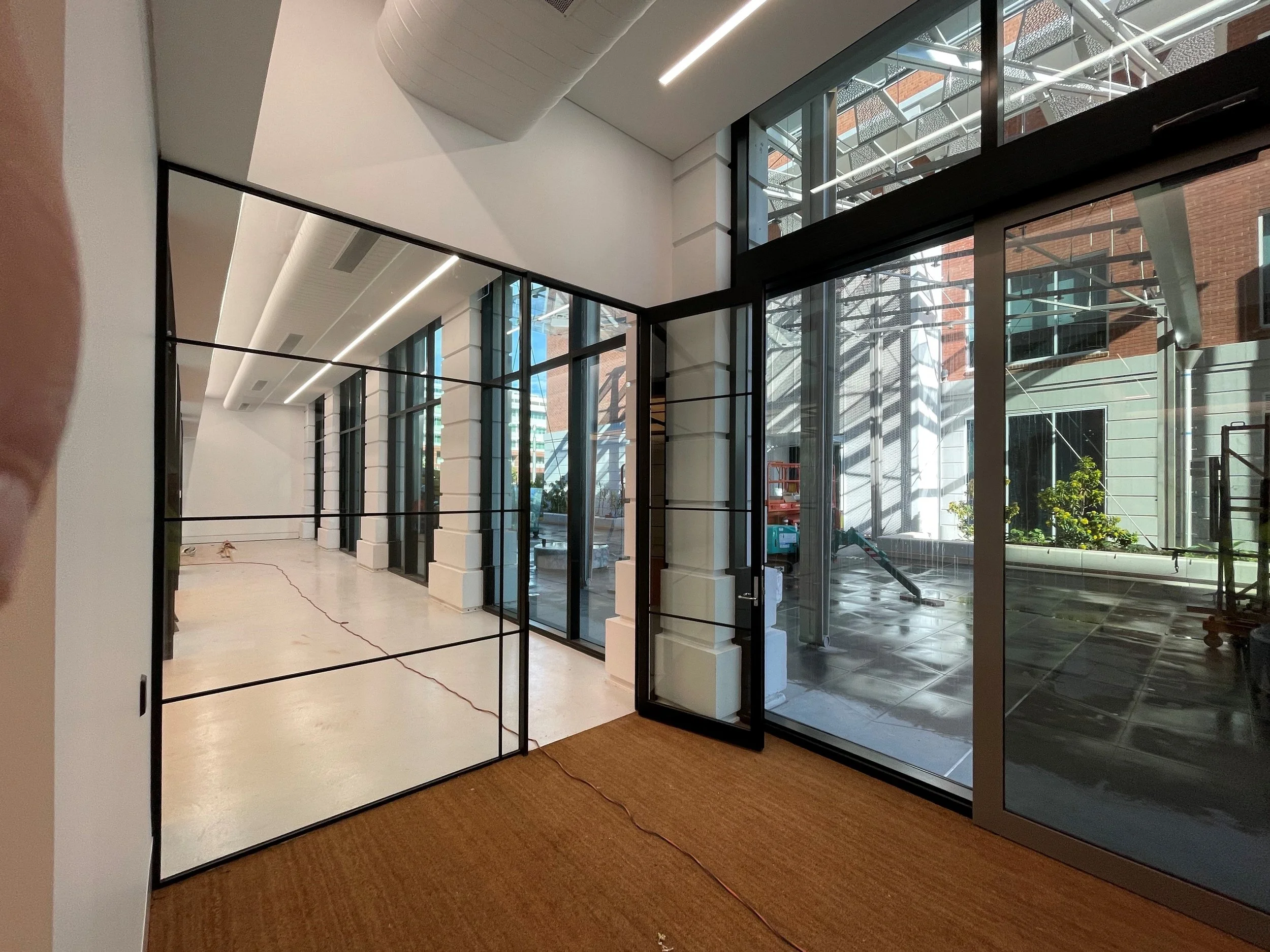 Epoxy floor finish visible through glass partitions — Lot Fourteen Bice Building fitout