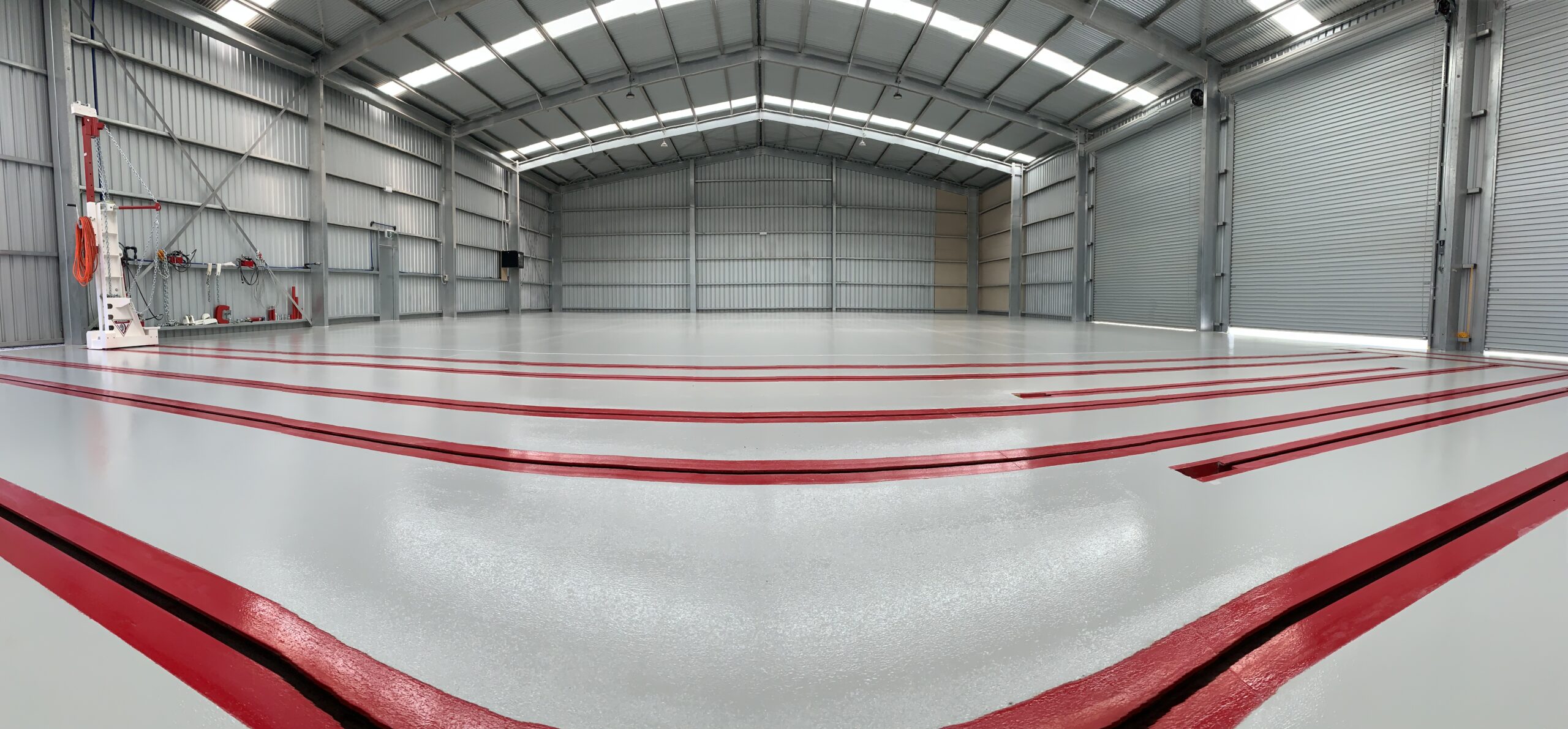 Completed epoxy floor coating — Mikutta workshop vehicle bays