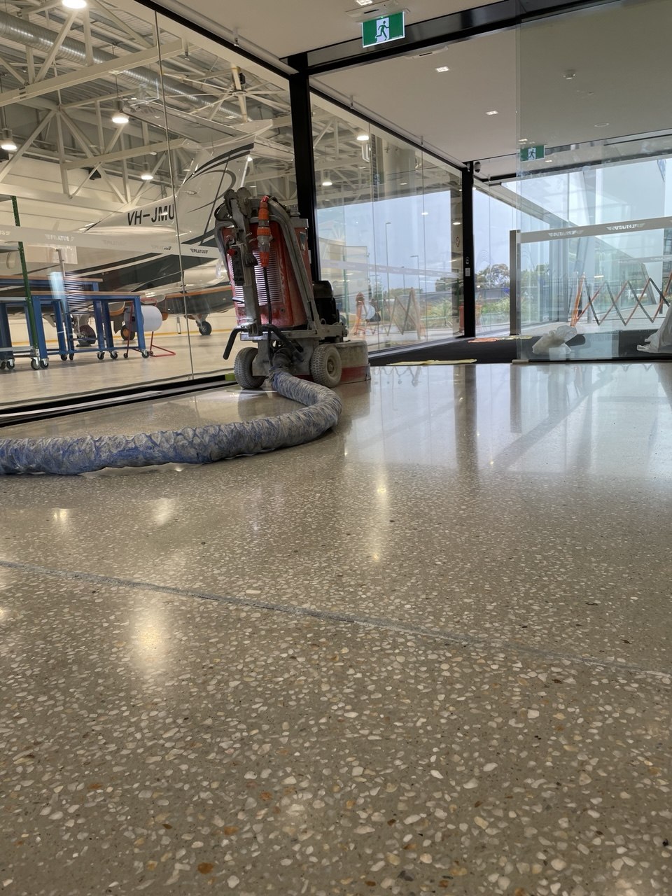 Floortek crew polishing concrete at Pilatus Adelaide Airport