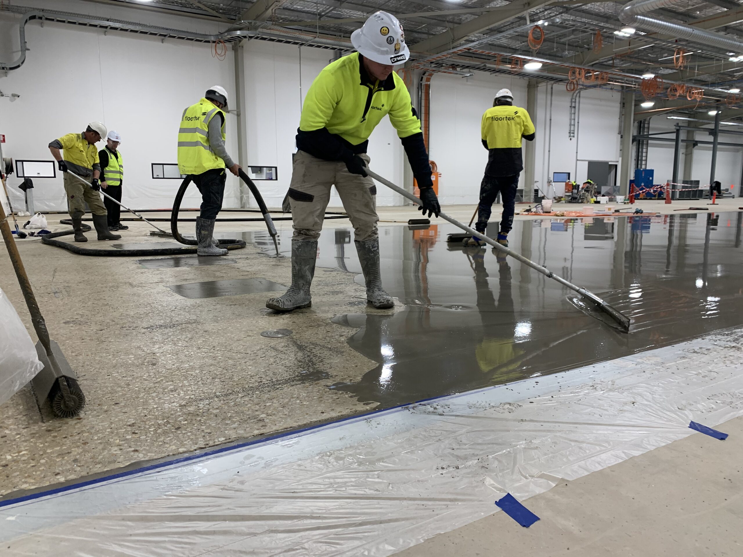 Contrast between prepped surface and new cementitious overlay being applied — PMB Defence Edinburgh